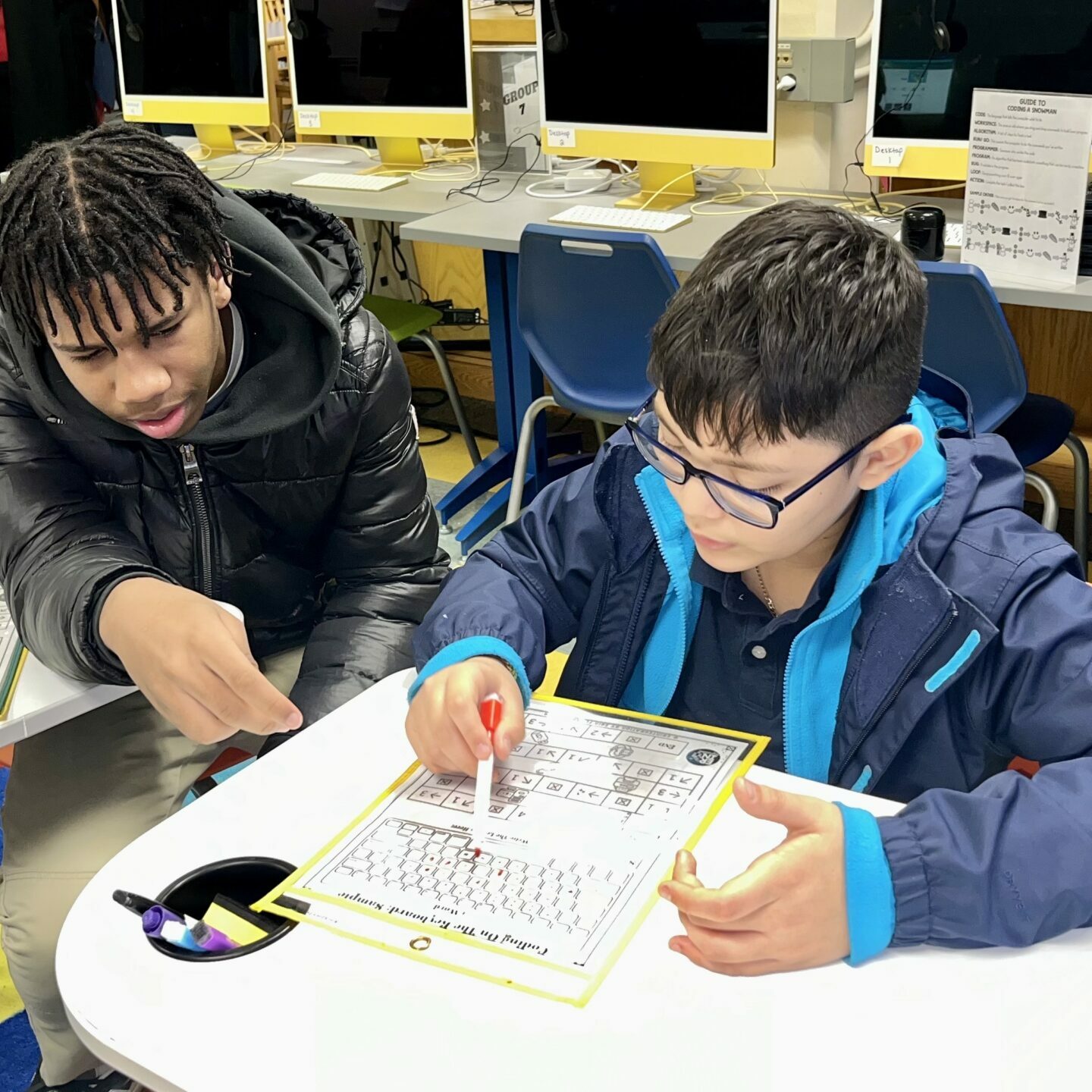 Students working on a math project Tilden Middle School students collaborating on a math project.